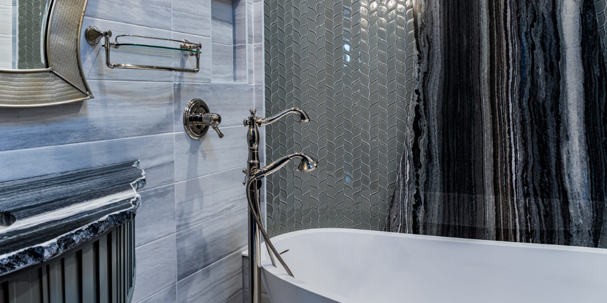 Bathroom with view of niche in wall and Black Widow marble behind tub and used for vanity top.