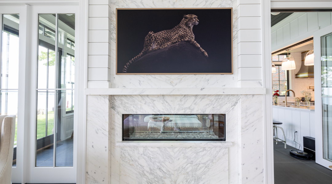 end stage of stone project process showing large marble fireplace with picture of jaguar over it.