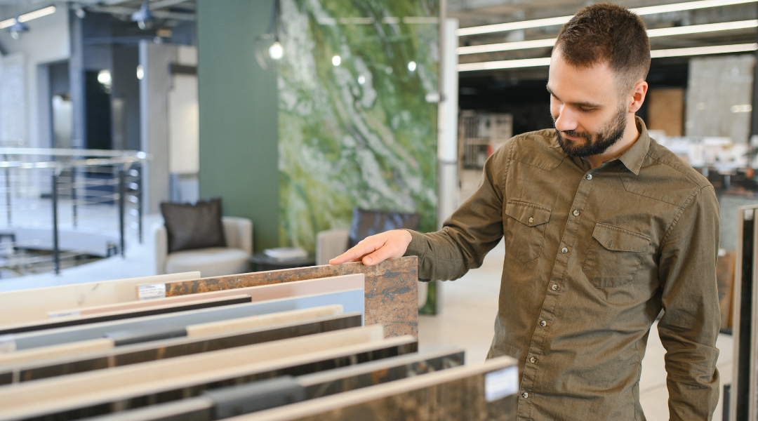 Man choosing from selection of natural stone samples