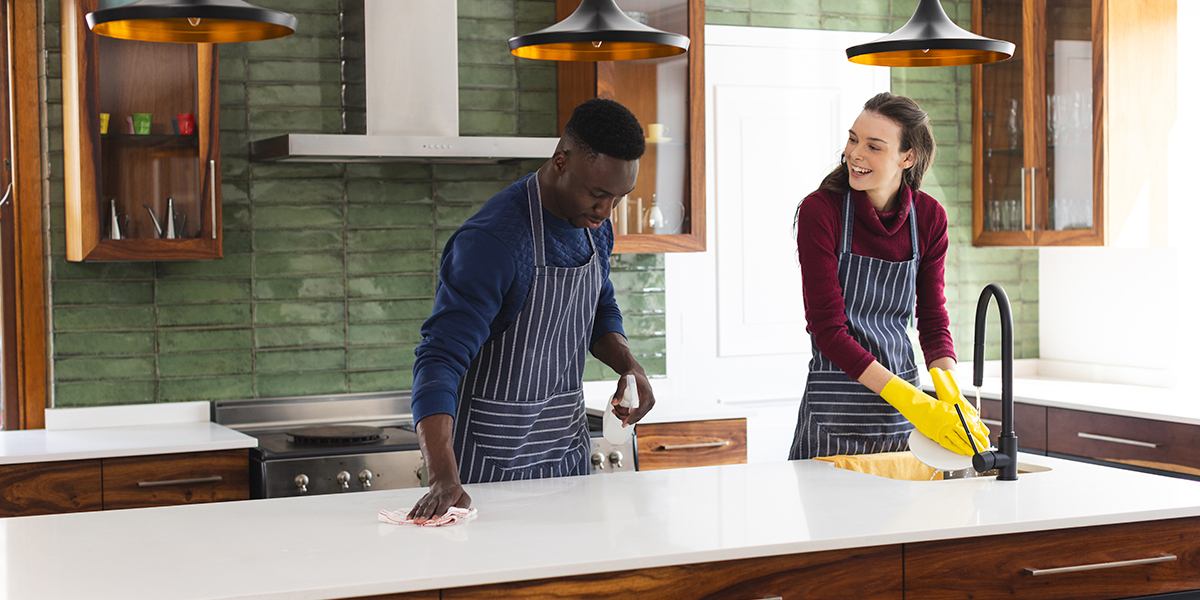Happy diverse couple cleaning countertop and doing dishes in kitchen at home Lifestyle togetherness relationship cleaning and domestic life unaltered - ZStone Creations Happy diverse couple cleaning countertop and doing dishes in kitchen at home