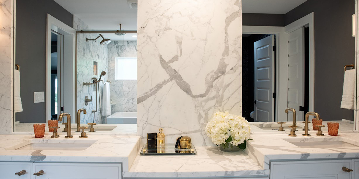 dual sink bathroom vanity with marble counters and backsplash