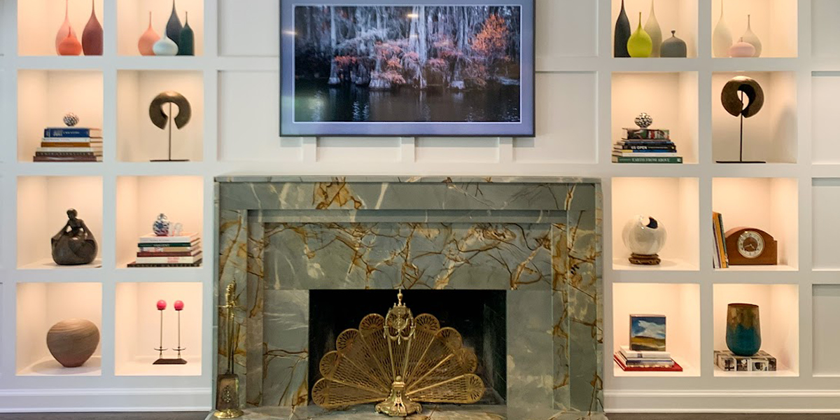 green and brown stone fireplace with built in bookshelves surrounding it